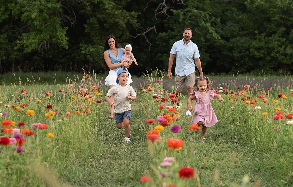 Dr. Williamson with his wife and children in a field