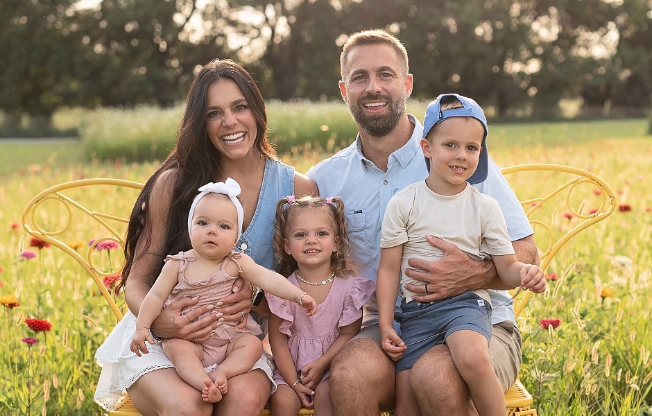 Dr. Williamson with his wife and children sitting on a bench